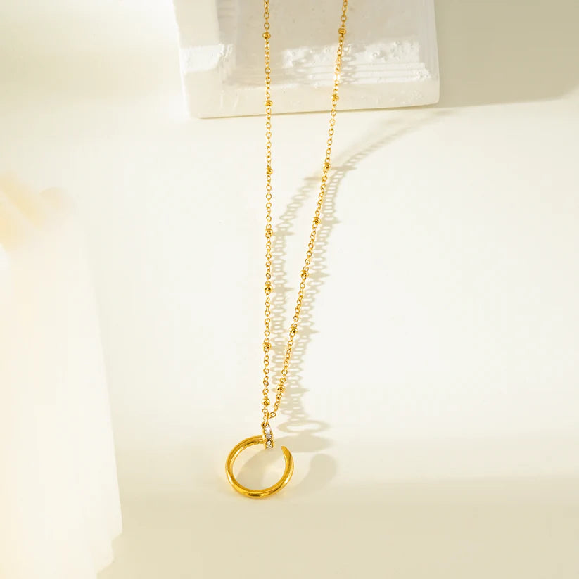 CSENGE Gold Necklace: Zirconia Embedded Circular Nail Pendant on a Satellite Beaded Chain