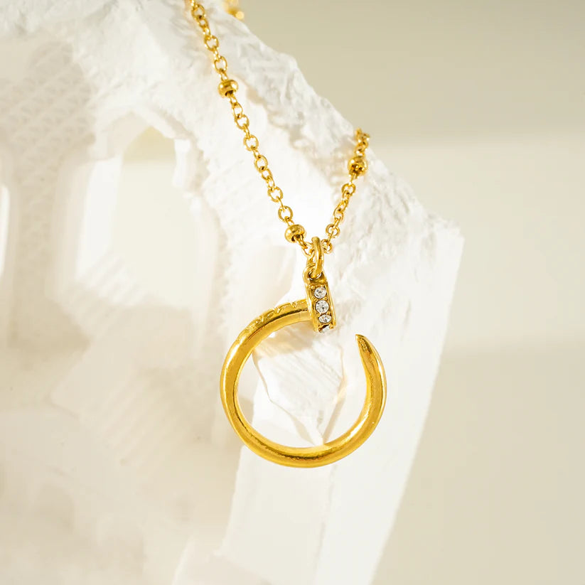 CSENGE Gold Necklace: Zirconia Embedded Circular Nail Pendant on a Satellite Beaded Chain